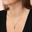 Close up of Labradorite Crystal Point Pendant Necklace in Gold on dark-haired model