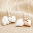 Mixed Metal Textured Double Heart Necklace in Silver with plain silver version on top of beige coloured fabric