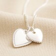 Textured Double Heart Necklace in Silver on Beige Fabric
