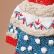 Close up of Blue Patterned Christmas Jumper Hanging Decoration against natural coloured background