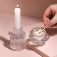 Model lighting tealight in small version of Two in One Medium Fluted Glass Candle Holder