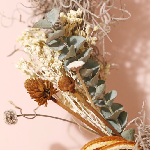 Close up of details on Gingerbread Christmas Wreath Making Kit against beige backdrop