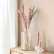 Lifestyle shot of Frosty Berry Dried Flower Bouquet With Candles 