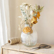 Lifestyle shot of Gingerbread Dried Flower Letterbox Gift in vase on table