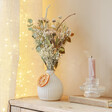 Lifestyle shot of Gingerbread Dried Flower Posy in Vase on Wooden Dresser
