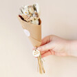 Merry Christmas Dried Flower Posy Letterbox Gift Wrapped in Paper and Held By Model
