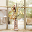 Winter Solstice Dried Flower Posy with Vase In Front of Snowy Window