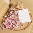 Pink Ixodia Daisy Dried Flower Wreath Making Kit supplies inside of box with flowers, base, twine and instructions card
