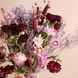 Close up of purple and pink flowers and grasses in the Summer Nights Dried Flower Bouquet