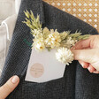 Model taking Natural Dried Flower Pocket Buttonhole out of suit jacket pocket
