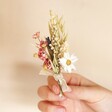 Wildflower Dried Flower Buttonhole Held by Model on Beige Background