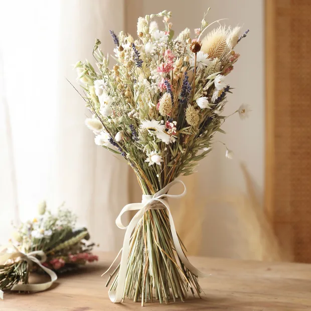 Wildflower Dried Flower Wedding Bouquet Wildflower Dried Flower Wedding Bouquet Standing on Wooden Table With Window in Background