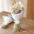 Wildflower Dried Flower Wedding Bouquet Standing on Wooden Table With Smaller Bouquet Laying in Background 