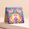 Tiger Compact Mirror open leaning on top of beige coloured raised surface