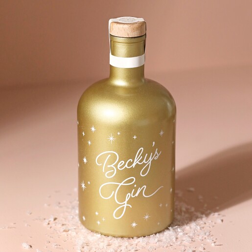 Personalised 700ml Gold Starry Gin on top of fake snow with beige coloured background