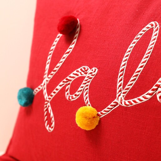 Close up of embroidery on Falala Embroidered Red Pom Pom Cushion 