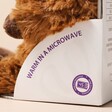 Close up of side of packaging on Warmies Junior Highland Cow Soft Toy