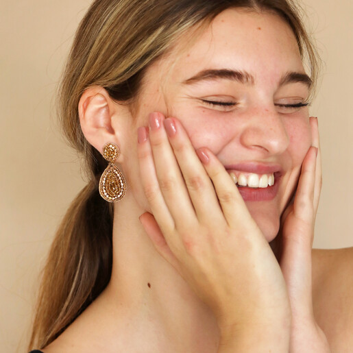 My Doris Gold Beaded Teardrop Drop Earrings on model with hands on cheeks smiling