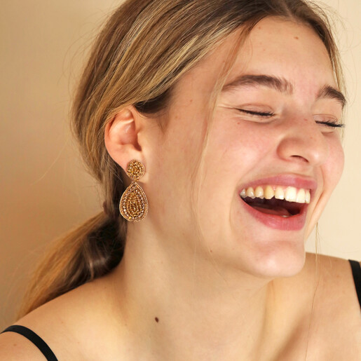 Model laughing wearing My Doris Gold Beaded Teardrop Drop Earrings