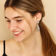 Model smiling looking down wearing My Doris Silver Beaded Teardrop Drop Earrings