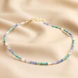 Full Chain of My Doris Set of Three Blue Beaded Necklaces on Beige Fabric
