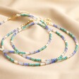 My Doris Set of Three Blue Beaded Necklaces Stacked Together on Beige Fabric