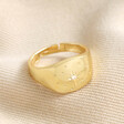 My Doris Adjustable Crystal Star Signet Ring in Gold on neutral coloured fabric