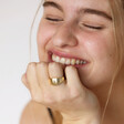Model smiling wearing My Doris Adjustable Crystal Star Signet Ring in Gold 
