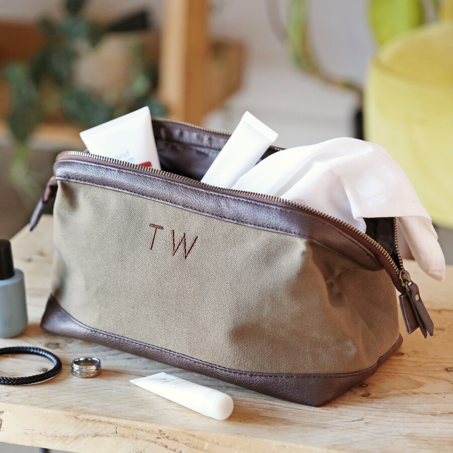 Lifestyle shot of Personalised Men's Canvas Wash Bag in Brown with toiletries coming out of bag