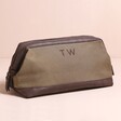 Personalised Men's Canvas Wash Bag in Brown Against Pink Background