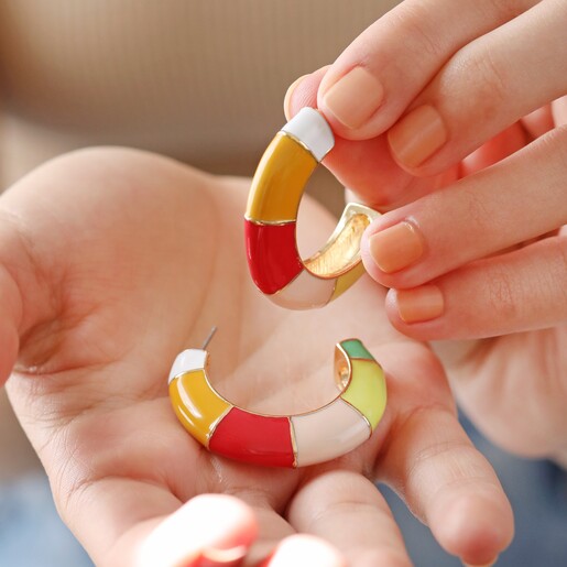 Earrings in Model's Hands Colourful Enamel Striped Hoop Earrings in Gold Held in Model's Hands