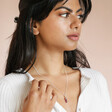 Model wearing the Amethyst Crystal Point Necklace in Silver with a white shirt