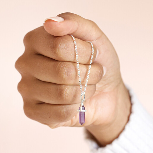 Model holding the Amethyst Crystal Point Necklace in Silver in fist