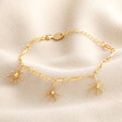 Ball and Star Paperclip Chain Bracelet in Gold on Beige Background