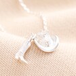 A double pendant necklace in silver with a cowboy boot and hat charm attached to a trace chain