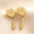 Heart and Teardrop Earrings in Gold on Beige Background