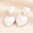 A stunning pair of silver plated earrings with butterfly backs. The hearts are 3D and lightweight. The smaller heart is attached to the larger heart by a chain link.