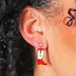 Close Up Model Shot of Red Enamel Cowboy Boot Drop Earrings in Gold