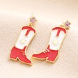 Red Enamel Cowboy Boot Drop Earrings in Gold against Beige Backgrounf