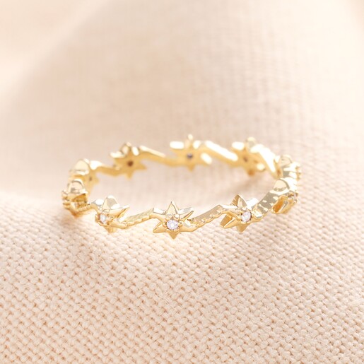 Sterling Silver Crystal Star Ring in Gold Sterling Silver Crystal Star Ring in Gold on a Beige Background.