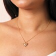 Close up of Sunbeam Heart Pendant Necklace in Gold on model