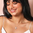 Sunbeam Heart Pendant Necklace in Silver on model against beige backdrop