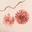 Two paper baubles that unfold and connect with a magnet