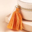 Close Up of Orange Tassel on Zip of Embroidered Leaves Mini Round Linen Travel Jewellery Case