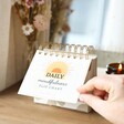 The First Page of the Daily Mindfulness Chart Being Turned on a Wooden Desktop