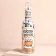 Popcorn Kitchen Chocolate Eyeballs Gift Bottle on a beige background, full of popcorn kernels, chocolate buttons and eyeball foil covered chocolate balls