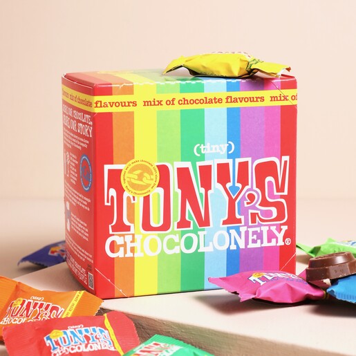 Tony's Chocolonely Tiny Tony's Christmas Gift Box in front of neutral background with mini chocolates surrounding the box
