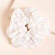 White Sheer Lace Floral Hair Scrunchie on Neutral Background