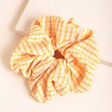 Orange Gingham Hair Scrunchie on Neutral Background