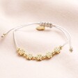 Estella Bartlett Flower Chain Friendship Bracelet on Beige backgounf